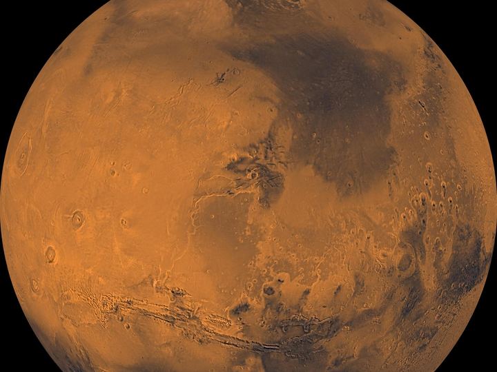 Global color views of Mars showing its rusty red surface, dark markings and polar ice
